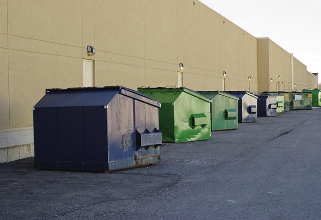 multiple construction dumpsters at a worksite holding various types of debris in Detroit Lakes